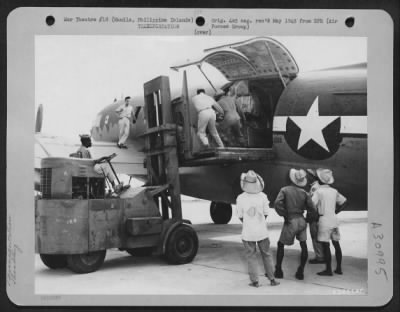 Thumbnail for Consolidated > An Air Force engine is loaded aboard a Curtiss C-46 cargo plaen at an airbase, Manila, Philippine Islands.