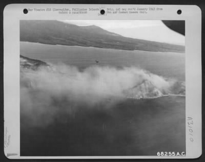 Thumbnail for Consolidated > Douglas C-47 just completing paratroop dropping pass and entering pattern for the next drop. Smoke is from the naval shelling of the San Jose area, where amphibious landing was made. 1944.