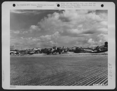 Consolidated > Wreckage of U.S. Air Force planes lines the runway at the Lingayen Air Strip, Luzon, Philippine Islands. 20 May 1945.