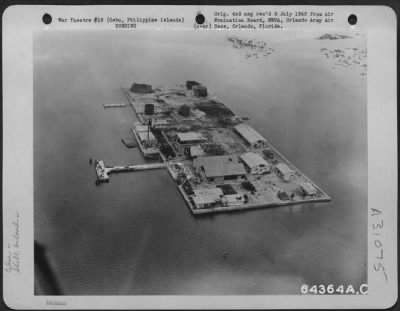 Thumbnail for Consolidated > An aerial view of Shell Island just off Cebu City, that was used as a pre-war refueling base for ships that piled these waters. May 1945, Cebu, Philippine Islands.