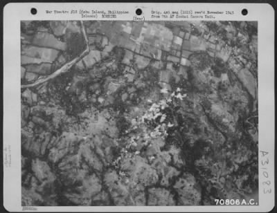 Thumbnail for Consolidated > Bombs, dropped from 494th Bomb Group Consolidated B-24 "Liberators," burst on the target-a Japanese bivouac area in a partially wooded section about six miles west of Cebu City, Cebu Island in the Philippines. 25 March 1945.