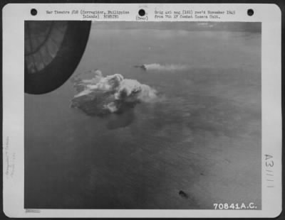 Thumbnail for Consolidated > Bombs, dropped from Consolidated B-24 "Liberators" of the 494th Bomb Group, burst on their targets-Corregidor and Caballo Island in the Philippines. 14 February 1945.