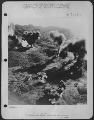 Thumbnail for Consolidated > Pillars of smoke towered 3000 ft., after napalm attack by 5th AF fighters, despite the fact that four inches of rain drenched the Ipo area (Luzon, P.I.) just prior to the strikes. Some 5th AF pilots even managed to plop their bombs into cave mouths