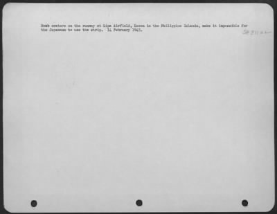 Consolidated > Bomb craters on the runway at Lipa Airfield, Luzon in the Philippine Islands, make it impossible for the Japanese to use the strip. 14 February 1945.