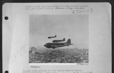 Consolidated > Douglas C-47S Spraying Ddt Over Bombed Areas In Manila, Philippine Islands.  April 1945.