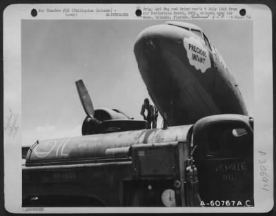 Consolidated > C-47, 'The Precious Infant', Being Refueled At Lingayen Airstrip Prior To Take-Off For Iaoag Airstrip, Luzon, Philippine Islands.  This C-47 From The 318Th Troop Carrier Command And 64Th Air Service Group Is Based On Laoag Airstrip.  20 May 1945.