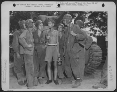 Consolidated > Members Of A Tank Corps Listen Intently As An Internee, Who Lost 78 Pounds And Is Suffering From Beri-Beri, Talks Over The Days He Spent In The Santo Tomas Compound In Manila, Luzon, Philippins Islands.  The Group Inclides, Left To Right:  Pfc. Arnold Sen