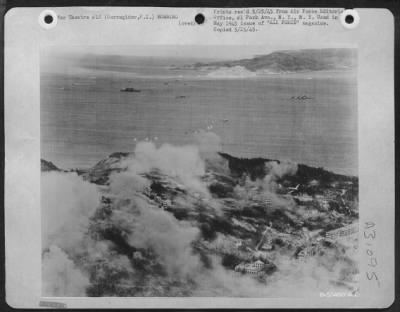 Consolidated > A Low Flying Transport Drops Its 'Stick' Of 8 Paratroops Squarely On Target On The Shattered, Bomb Pocket Ruin Of Corregidors Topside.