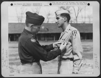 Consolidated > An Officer Presents The Distinguished Flying Cross To A Member Of The 1330Th Aaf Base Unit, Air Transport Command, During A Ceremony At An Airbase At Jorhat, Assam, India. 20 March 1945.