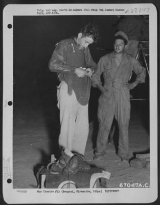 Consolidated > At an air base near Bengasi, Cirenaica, Libya, 1st Lt. John E. McAttee of San Francisco, California, fastens on his "flak suit" just prior to boarding a plane to bomb the Ploesti, Roumania oil fields and refineries. Early reports from the