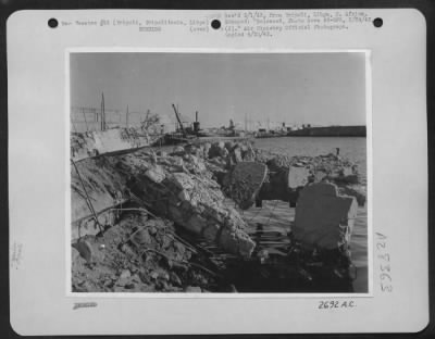 Thumbnail for Consolidated > A jetty built of reinforced concrete blown to pieces in Tripoli Harbor, Tripolitania, Libya, by bombs from Allied aircraft. Tripoli harbor and the shipping there suffered extensive damage from our bombing, and many thousands of tons of Rommel's