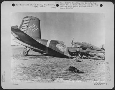 Thumbnail for Consolidated > A Hurricane fighter ready to take off from the landing ground at Castel Benito, Tripolitania, Libya. In the foreground is the wreck of a Focke-Wulf "Condor." 26 January 1943.