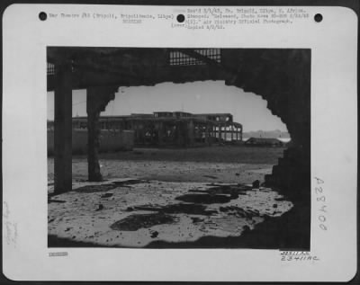 Thumbnail for Consolidated > Warehouses on the waterfront at Tripoli, Tripolitania, Libya, shattered by bombs dropped on the port by the Allied Air Forces. Thousands of tons of vital war materials stored here were blown to pieces by our bombs. February 6, 1943.