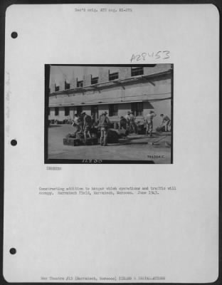 Consolidated > Constructing addition to hangar which operations and traffic will occupy. Marrakech Field, Marrakech, Morocco. June 1943.