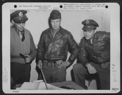 Thumbnail for Consolidated > Berteaux, Morocco-Air Corps Intelligence Officers of the 316th Bomber Unit during a discussionon enemy ack ack gun positions. (L to R) Lt. Rupert A. Nock, Newburyport, Mass., Capt. W.G. Gridley, Locust, New Jersey and Lt. Edward P. Meehan, Hamiliton