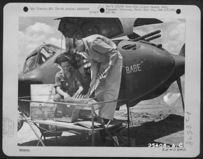 Thumbnail for Consolidated > 1st Lt. H.A. Blood examining ammunition being loaded into the Lockheed P-38 "BABE" of the 14th Fighter Group.