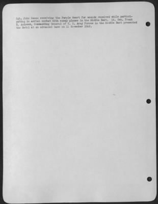 Consolidated > Sgt. John Banco receiving the Purple Heart for wounds received while participating in aerial combat with enemy planes in the Middle East. Lt. Gen. Frank M. Andrews, Commanding General of U.S. Army Forces in the Middle East presented the Medal at an