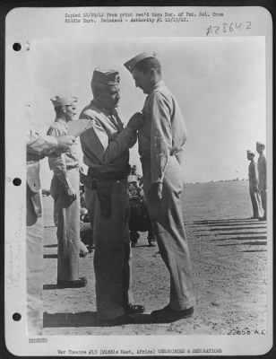 Thumbnail for Consolidated > 2nd Lt. Donald M. Wilder, Bombardier, of Savannah, Ga. Receives the Silver Star from Lt. Gen. Frank M. Andrews, Commanding General of U.S. Air Forces in Middle East on 11 Nov at an advanced base somewhere in the Middle East. While attacking an enemy