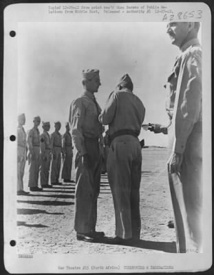 Consolidated > Sgt. Jack D. Smith, of Daly City, Calif., receiving the Silver Star for outstanding gallantry and cooperation while under fire. His ship was attacked by two M.E. 110's and a JU. 88 which set on fire the No. 1 engine and caused an oil leak on the