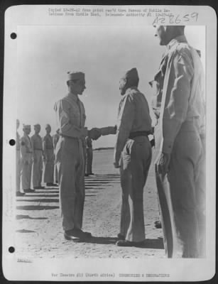 Consolidated > Sgt. Joseph A. Gauthier, Aerial Gunner form Pawtucket, R.I., shakes hands with Lt. Gen. Frank M. Andrews, Commanding General for U.S. Army Forces in the Middle East, after receiving the Silver Star for his determination and skill during a bombing