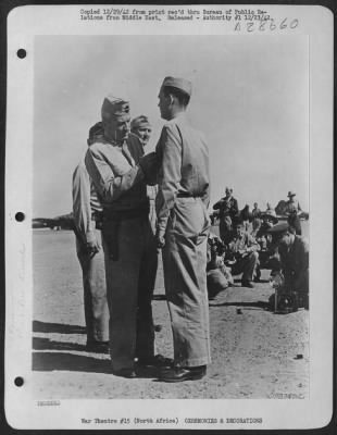 Consolidated > S/Sgt. Grover L. Knox, engineer-gunner, of Columbus, Georgia, being decorated with the Silver Star by Lt. General Frank M. Andrews, Commanding General of USAF in the Middle East. During at attack on Tobruk Harbor, the ship was hit in numerous places