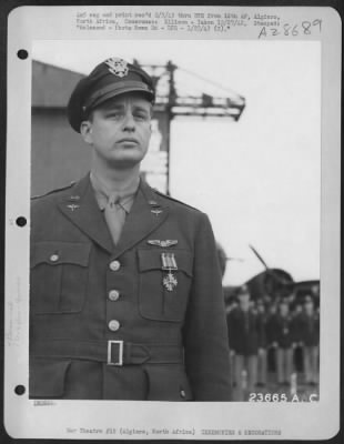 Consolidated > Lt. Col. Elliott Roosevelt receives the Distinguished Flying Cross in Algiers for outstanding services performed by his Group in the African Campaign.
