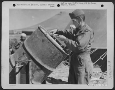 Thumbnail for Consolidated > Algiers, Algeria-Salvage worker tightening top of reclamation drum used for cleaning and salvaging of small parts such as nuts and bolts, washers, etc. April 1943.