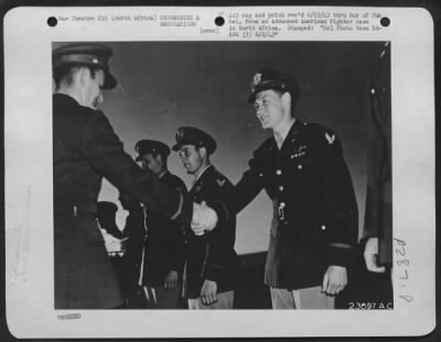 Consolidated > Shown above is 2nd Lt. William J. Sloan, Richmond, Va., receiving the Silver Oak Leaf Cluster, in lieu of the fifth bronze Oak-Leaf Cluster for the Air Medal, which he had been awarded previously. Lt. Col. John W. Weltman, Rollesburg, W. Va.