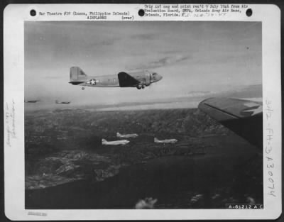 Thumbnail for Consolidated > Douglas C-47 "Skytrains" in formation over Lake Taal, Luzon, Philippine Islands.