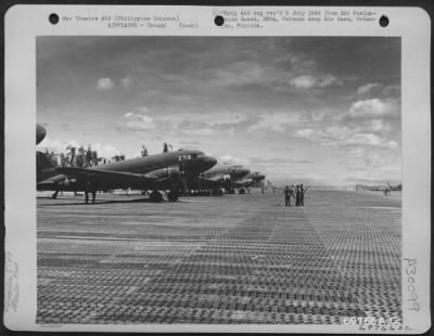 Thumbnail for Consolidated > Douglas C-47s are parked on the line at an airstrip somewhere in the Philippine Islands.