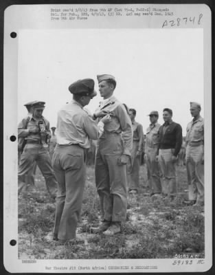 Thumbnail for Consolidated > 2nd Lt. Dale R. Deniston, Akron, Ohio, receiving the Distinguished Flying Cross from Maj. Gen. Lewis H. Brereton. NORTH AFRICA.