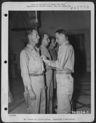 Consolidated > Photographic Reconnaissance Wing, is presented the Legion of Merit by Lt. Gen Carl A. Spaatz during ceremonies on 5 September 1943 at an unidentified airbase in North Africa.