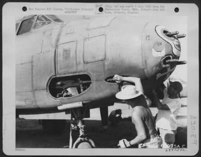 Thumbnail for Consolidated > Armorers put tape on the ends of the barrels of .50 cal side guns on a Douglas A-20; this is done to prevent dust from collecting in the barrels after they have been cleaned. The tape is removed just before the plane takes off on a mission.