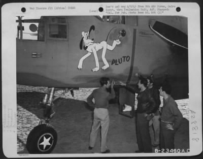 Thumbnail for Consolidated > "Walt Disney will love this!" "Pluto" gets a break as Lt. John J. Privara of Lions, Ill. And Capt. James T. McKee of Picayune, Miss., Pilot of the North American B-25 along with Lt. Russel E. Wise of Arlington, Mass. Co-pilot and William L. Lewis