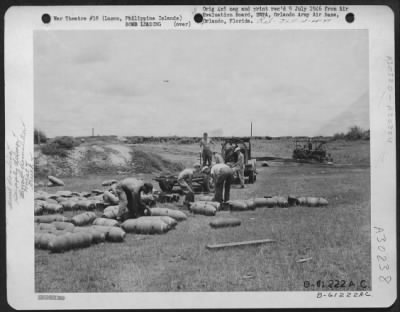 Thumbnail for Consolidated > Armament men fitting fins on 250 pound and demolition bombs just before loading them on the bomb trailer. Clark Field, Manila, Luzon, Philippine Islands. 8 August 1945.