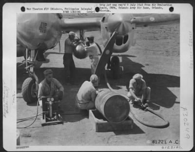 Thumbnail for Consolidated > Immediately after mixing the Napalm solution, the filled drums are taken by truck to the waiting plane. Three 55 gallon drums are required to fill each tank and there are two tanks to a fighter-bomber. 894th Chemical Company, 3rd Bomb Group. Elmore