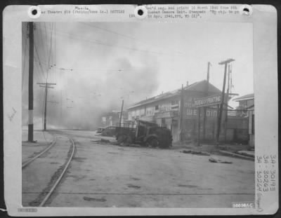 Consolidated > The intense fire which consumed Manila is shown as it moves down this row of houses on Avenida Tayuman in the Far Eastern University Sector. Scene is near notorious Bilibid prison around which an intense battle raged with the savagely resisting Jap.