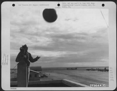 Thumbnail for Consolidated > An enlisted man at Payne Field, Cairo Egypt releases a hydrogen balloon which he will view through the theodolite to determine wind direction and velocity.