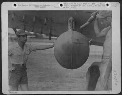 Thumbnail for Consolidated > Belly tanks are often filled with the Gel mixture after they are slung under the airplane's wing. This Lockheed B-34 Ventura in the Philippine Islands, was fitted with four rocket racks alongside the fire-bomb. The pilot watches as skilled chemical