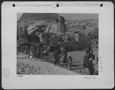 Thumbnail for Consolidated > Beneath the stare of the age old Sphinx, United States airmen fighting in the Middle East tour the historic "diggings" around the Pyramids on camel-back. The visit to these ancient wonders climaxed a week-end leave in Cairo, Egypt. 13 December 1942.