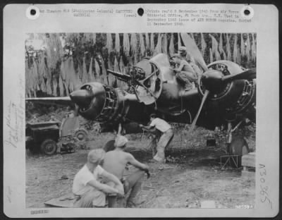 Thumbnail for Consolidated > With no self-starting apparatus on the Nick, two men crank right engine with a hand rope. Palawan Island, P.I.