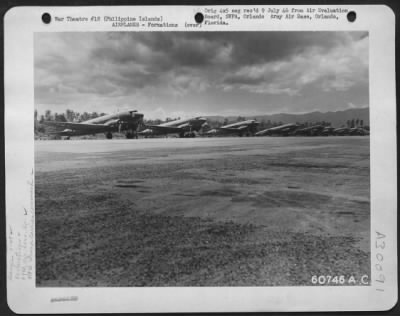 Thumbnail for Consolidated > Douglas C-47S Lined Up At Lingayen Air Strip Awaiting Cargo.  These Are Planes Of The 64Th Air Service Group, 318Th Troop Carrier Command From Laoag Air Strip In The Philippine Islands.  20 May 1945.