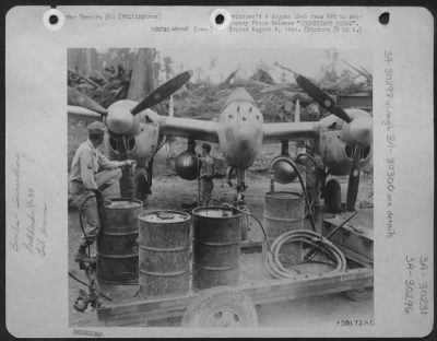 Thumbnail for Consolidated > Incendiary Bombs (#1 Of Two Pictures)  Twin Belly Tanks Of This P-38 Lightning  Of The 13Th Aaf Fighter Command Based In The Philippines Are Filled With Napalm Gel Transferred From The Drums By Air Pressure.  These Tanks Will Be Jettisoned Over Japanese T