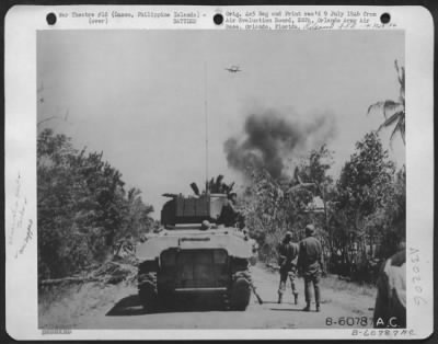 Thumbnail for Consolidated > Bombs Away Over Batangas Province, Luzon, Philippine Islands.  Two 300-Lb. Bombs, Visible Under The Fuselage Of A P-39, Are Headed For Japanese Installations Only 75 Yards In Front Of U.S. Infantry Advance.  Explosion In The Background Is From Artillery S