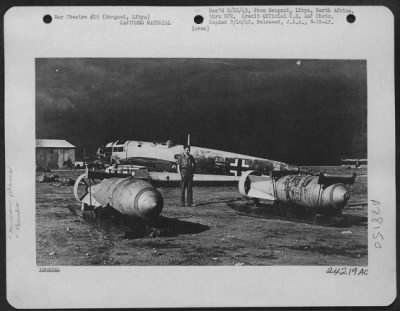 Thumbnail for Consolidated > When the United Nations airforces attacked this airfield near Bengasi, they forced the Nais to abandon much equipment and ammunition. In the foreground are two heavy bombs which will never be used against our forces. Note the sleds which were used