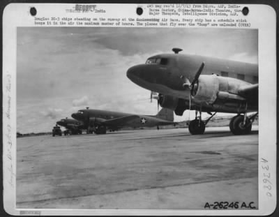 Thumbnail for Consolidated > Douglas DC-3 ships standing on the runway at the Air Base. Every ship has a schedule which keeps it in the air the maximum number of hours. The planes that fly over the "Hump" are unloaded a few minutes after landing and take off again for another