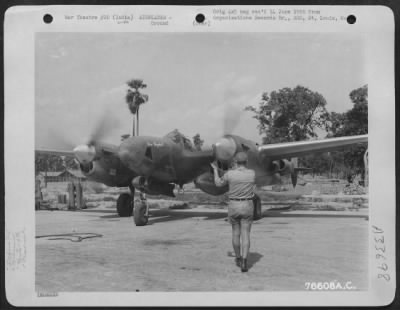 Consolidated > Sgt. Miller directs pilot of the 9th Photographic Reconnaissance Squadron in taxiing the Lockheed F-5 "MISS VIRGINIA E" out of revetment area at an air base somewhere in India.