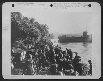 Consolidated > Landing at Hollandia in Humboldt Bay, New Guinea on 22 April 44. Allied troops hit the beach after debarking from LSTs.