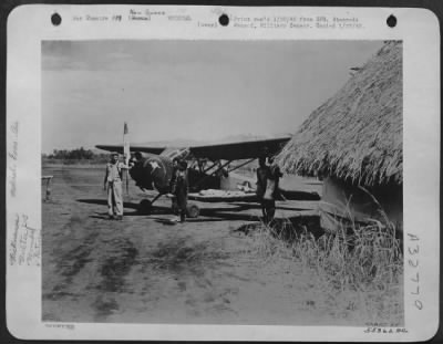 Thumbnail for Consolidated > Friendly natives assist in evacuation of sick and wounded in Vultee L-5. New Guinea.