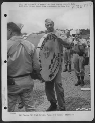 Thumbnail for Consolidated > Gary Cooper plays the drum with the 32nd Division Band at his own reception at Port Moresby, Papua, New Guinea, 7 December 1943. Mr. Cooper and party were touring the Pacific Islands, entertaining U.S. Troops.